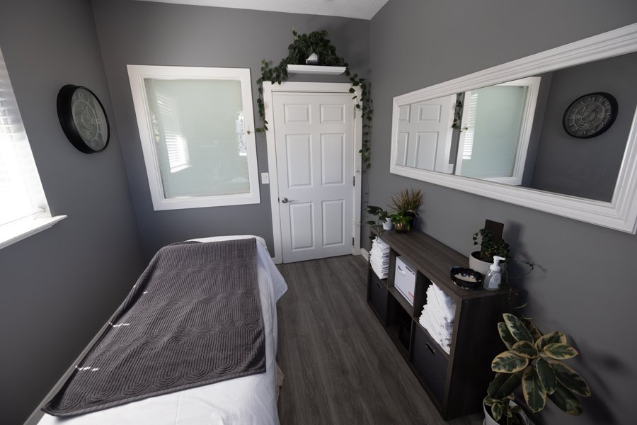 A treatment studio at CGW Studios with a massage table and warm natural light.