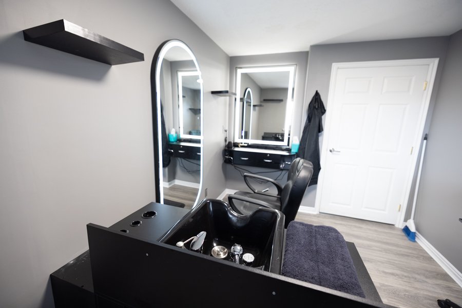 The full salon suite at CGW Studios with a wash station and stylist setup.