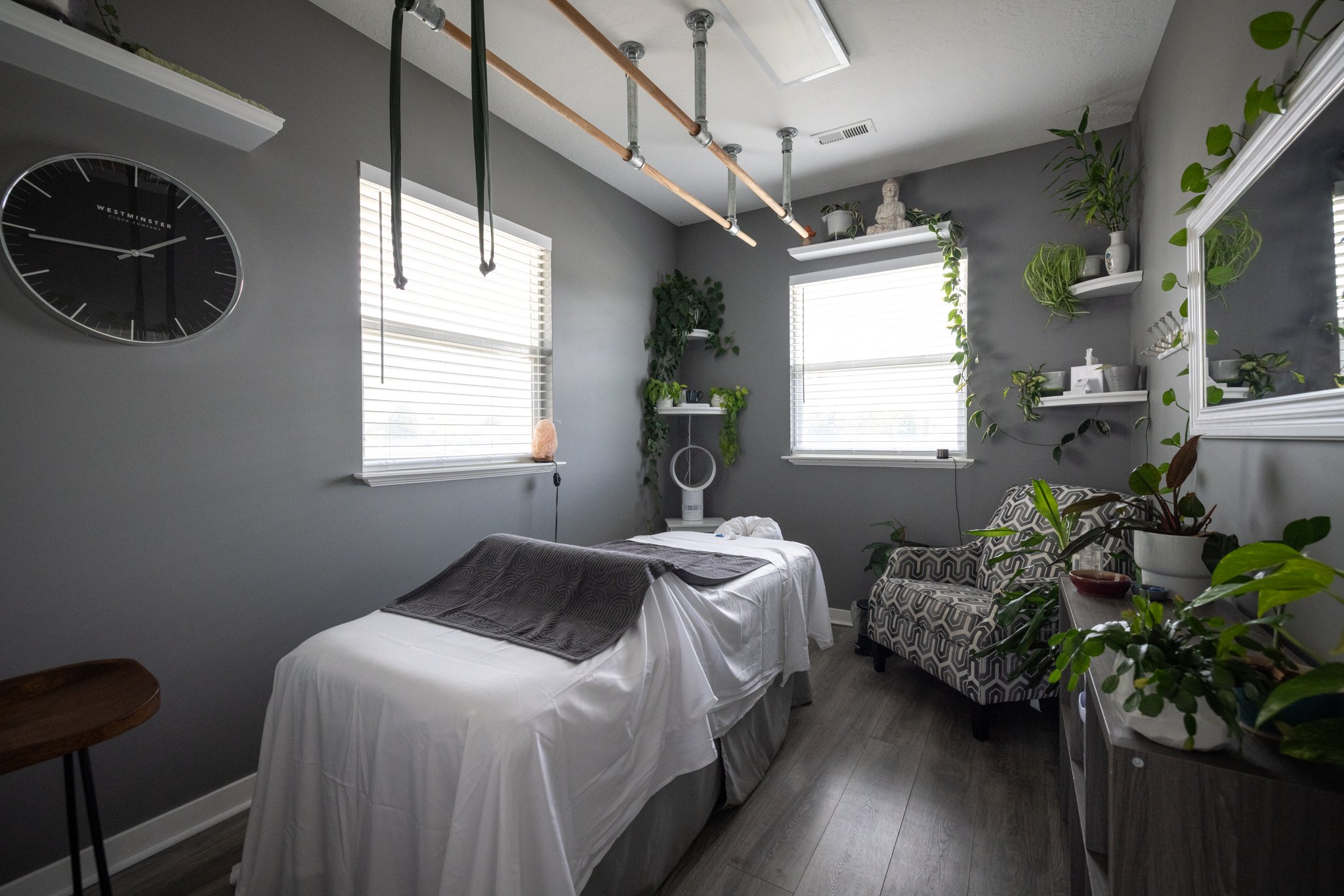 Studio 2 at CGW Studios showing the ceiling-mounted Ashiatsu bars and the massage table beneath them.