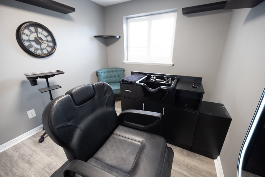 Wide view of Studio 6 Salon at CGW Studios showing the wash station and stylist chair.